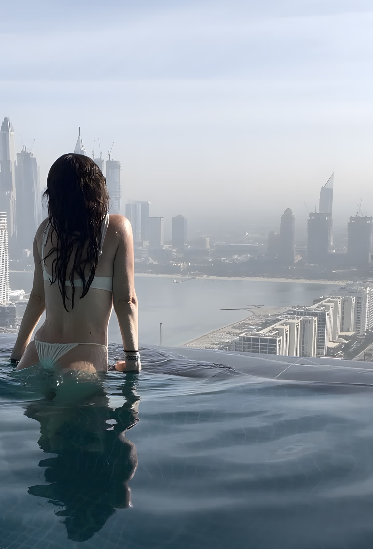 Julita in an infinity pool above the Dubai skyline